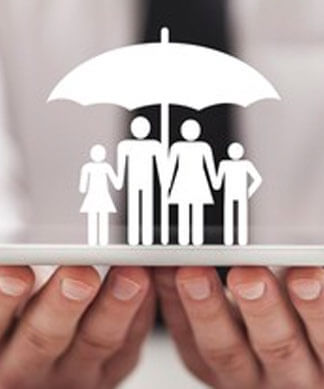 hands holding up a paper cutout of a family under an umbrella