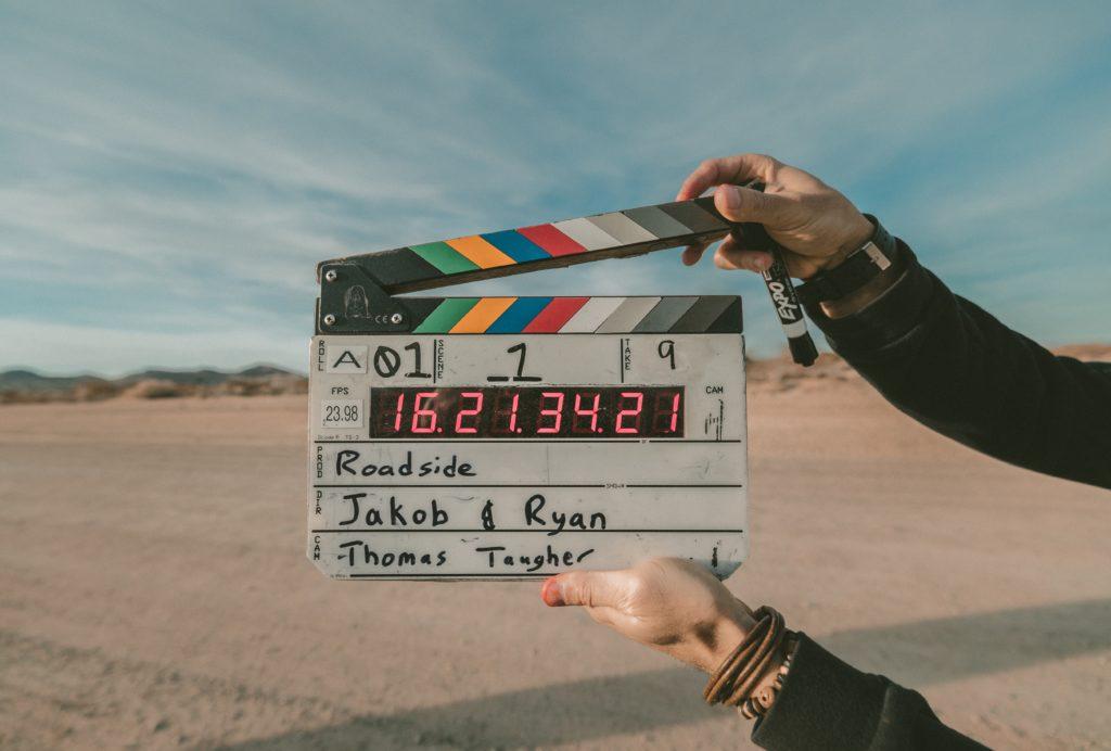 Male director holding clapper board
