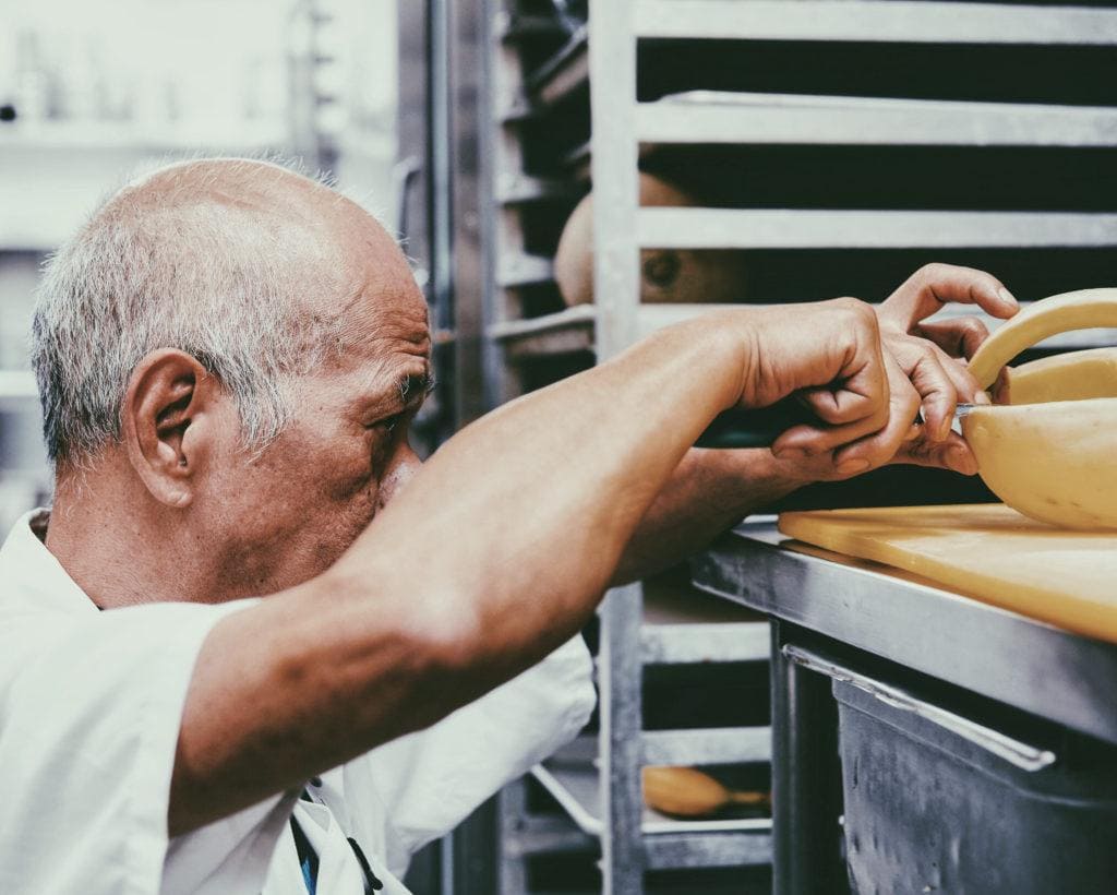 Elderly man working in a bakery