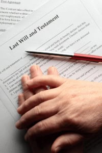 Last will and testament paper with couple hand on it