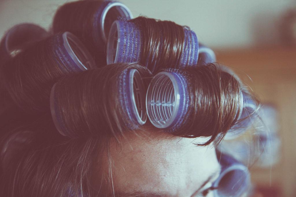 woman with purple hair curlers in