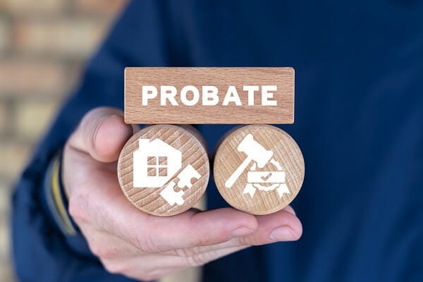 person holding blocks with pieces of the probate process