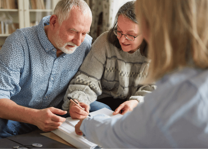 Michigan couple signing power of attoney documents with a elder law attorney